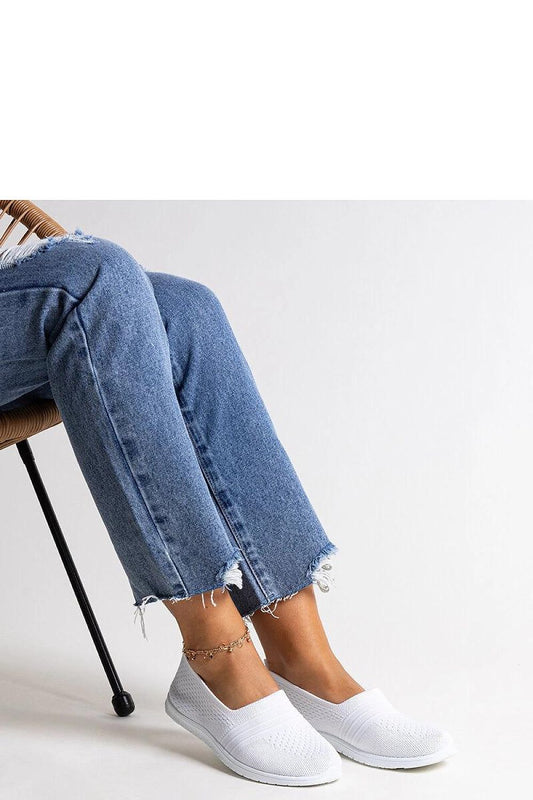 Close-up view of Solea women's white slip-on sneakers, highlighting their comfortable fabric and rubber sole, ideal for warm days.