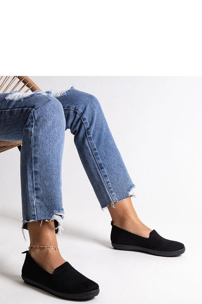 Chic Solea Shadhi black slip-on sneakers highlighting their stylish round toe and flexible fabric for effortless wear.