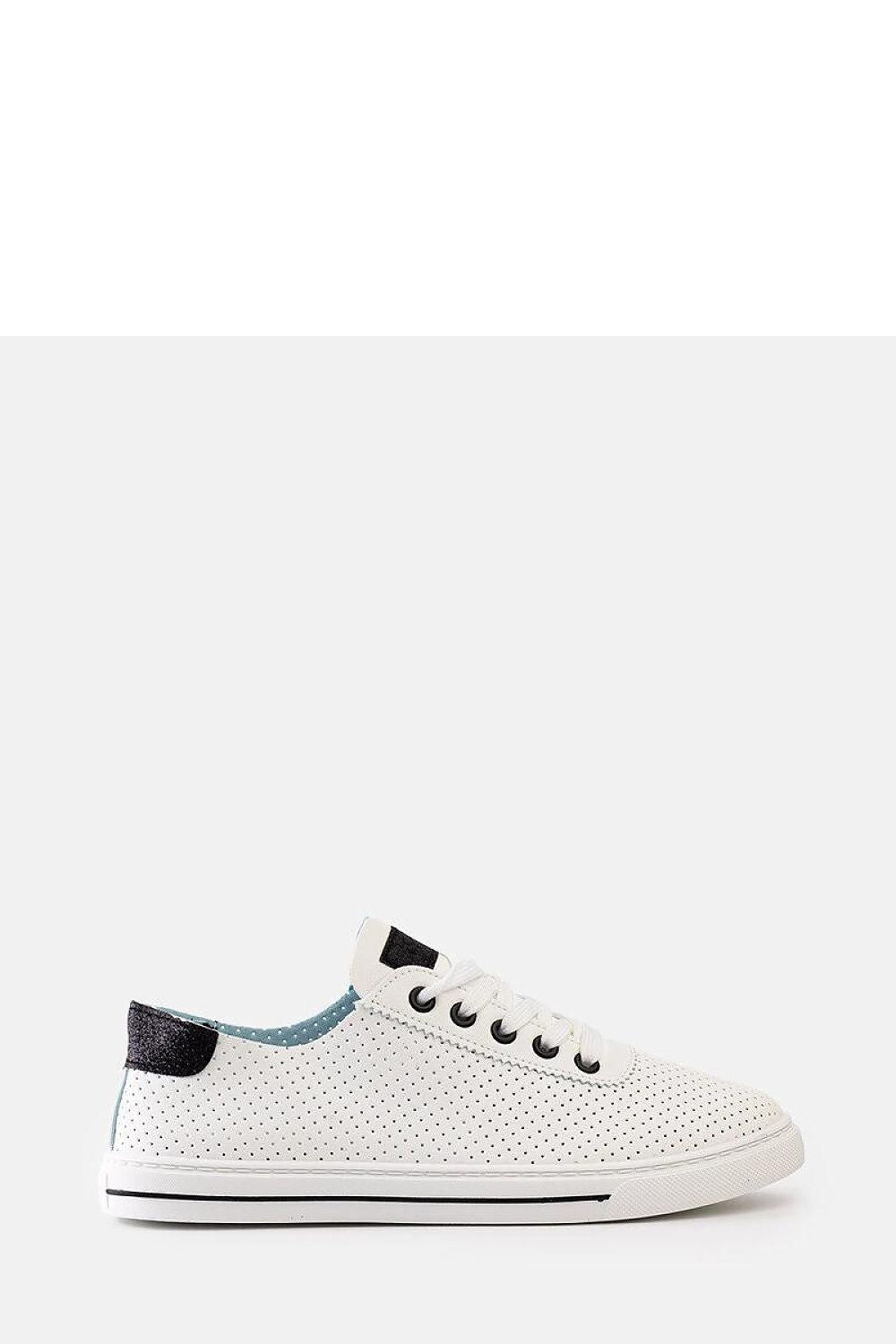 Lifestyle shot of Solea white perforated Ruala sneakers styled with summer attire, reflecting their trendy and fashionable appeal.