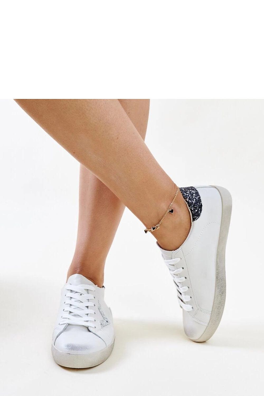 Solea sustainable footwear, white eco leather sneakers showcasing a fashionable worn effect for versatile wardrobe pairing.