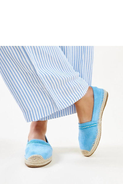 Solea blue espadrilles in a stylish setting, featuring a comfortable slip-on design and adorned with shimmering zirconias, ideal for summer elegance.