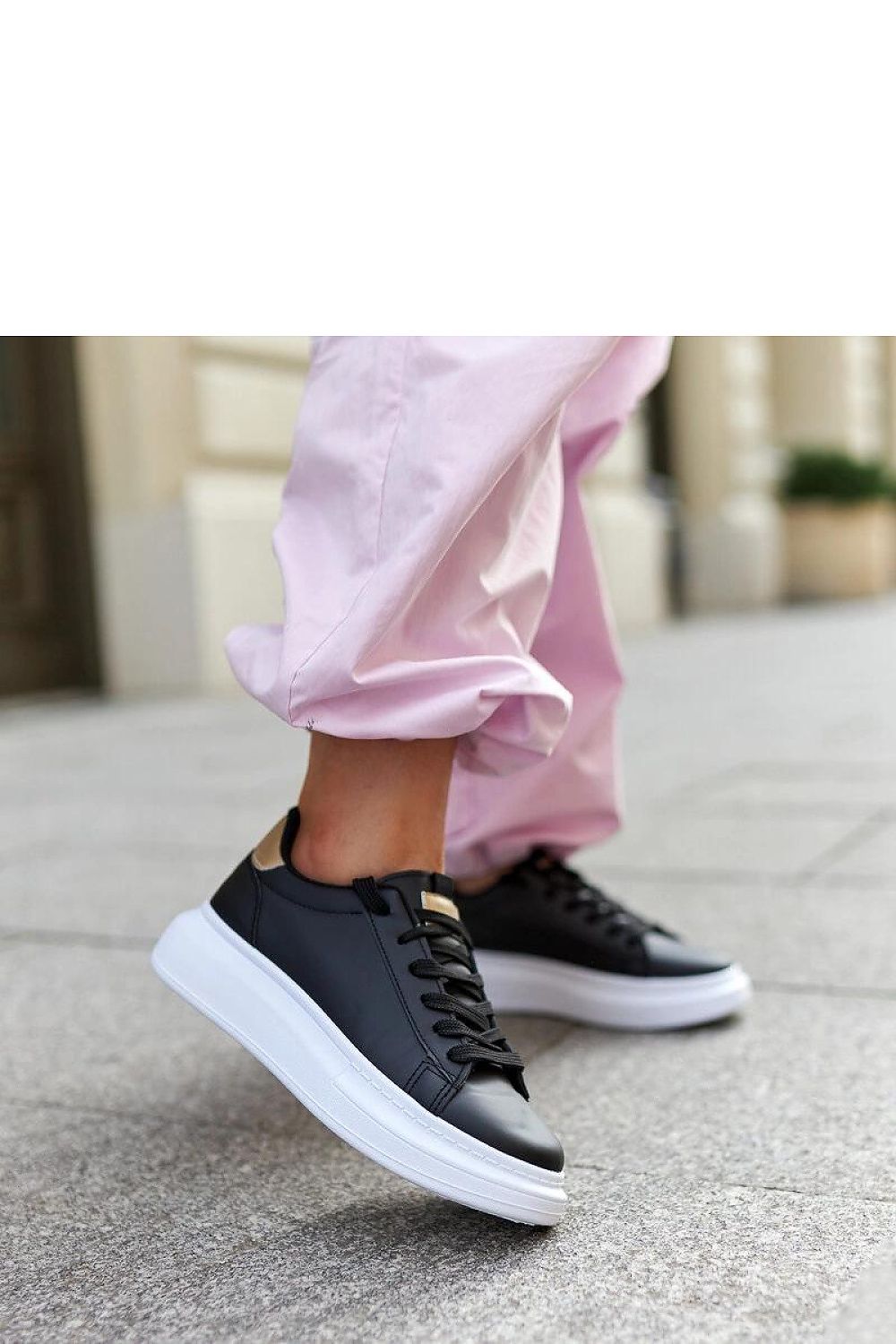 Solea luxurious black lace-up sneakers featuring a thick white rubber sole, designed for a stylish and contemporary look.