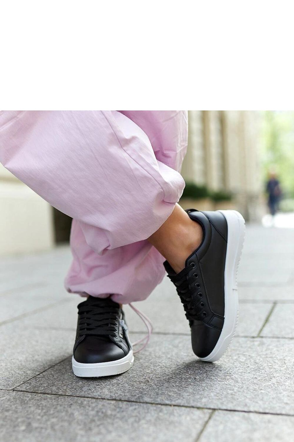 Chic Solea eco-leather sneakers in black, showcasing a low profile and cushioned rubber sole, designed for effortless sophistication.