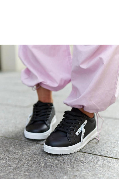 Solea Black eco-leather sneakers with a low cut design, showcasing the elegant round toe and white rubber soles, perfect for modern style.