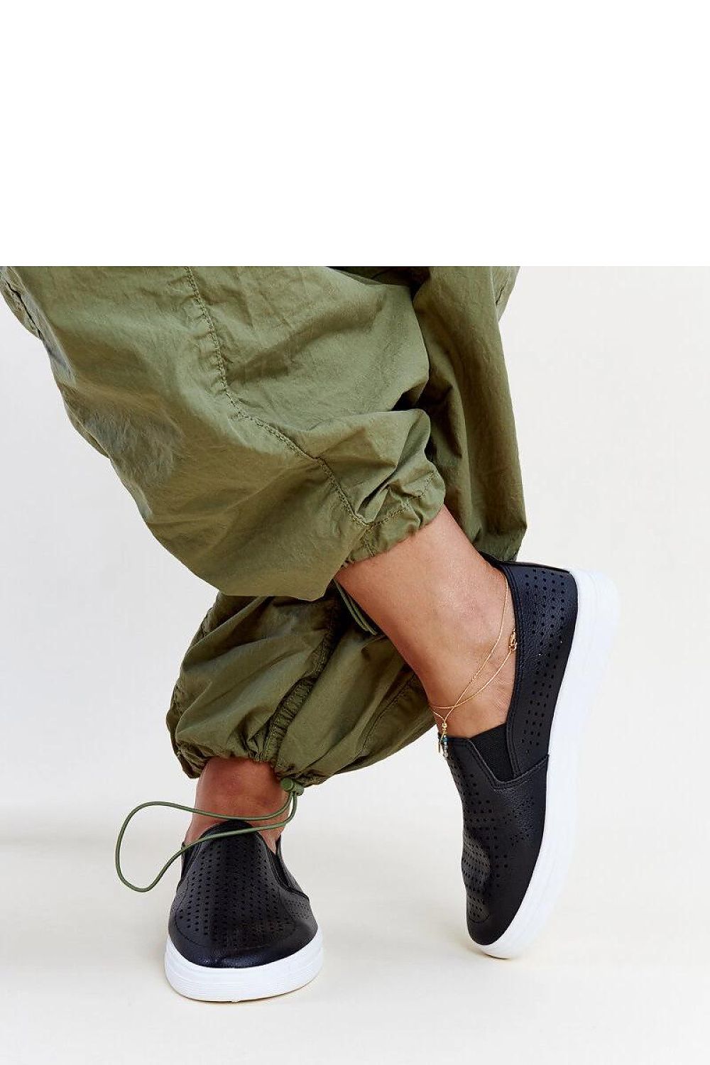 Luxurious view of Solea white slip-on sneakers, highlighting the quality eco leather and flexible rubber sole, ideal for fashion-forward women.