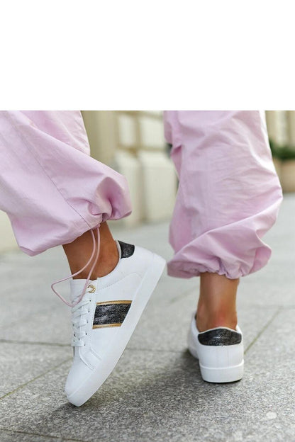 Solea white and gold sneakers displayed on a luxurious background, highlighting the trendy low profile design.