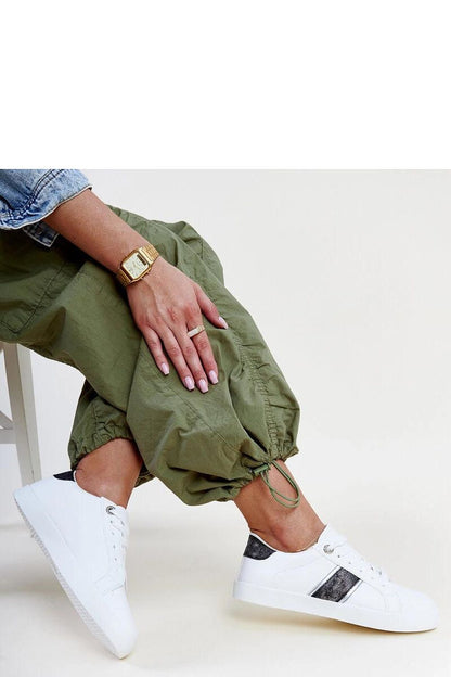 Chic Solea women's sneakers with a sophisticated low design and shimmering embellishments, perfect for elegant outfits.