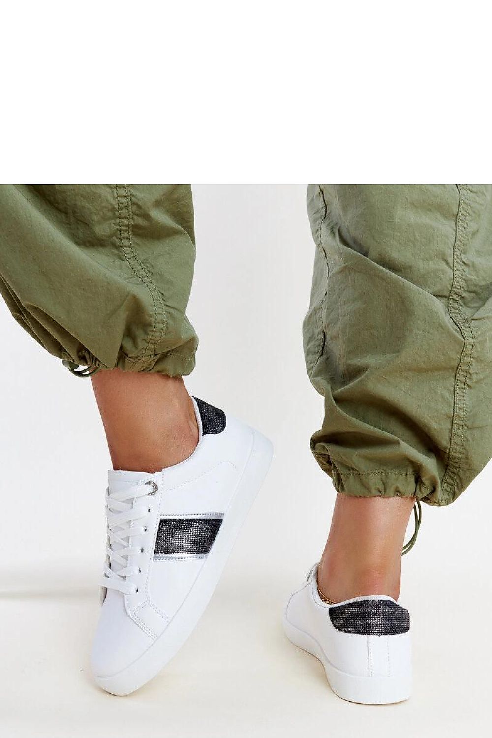 Close-up view of Solea white and gold women's sneakers showcasing the luxurious synthetic suede leather and decorative strap with zircons, ideal for a chic spring/summer collection.