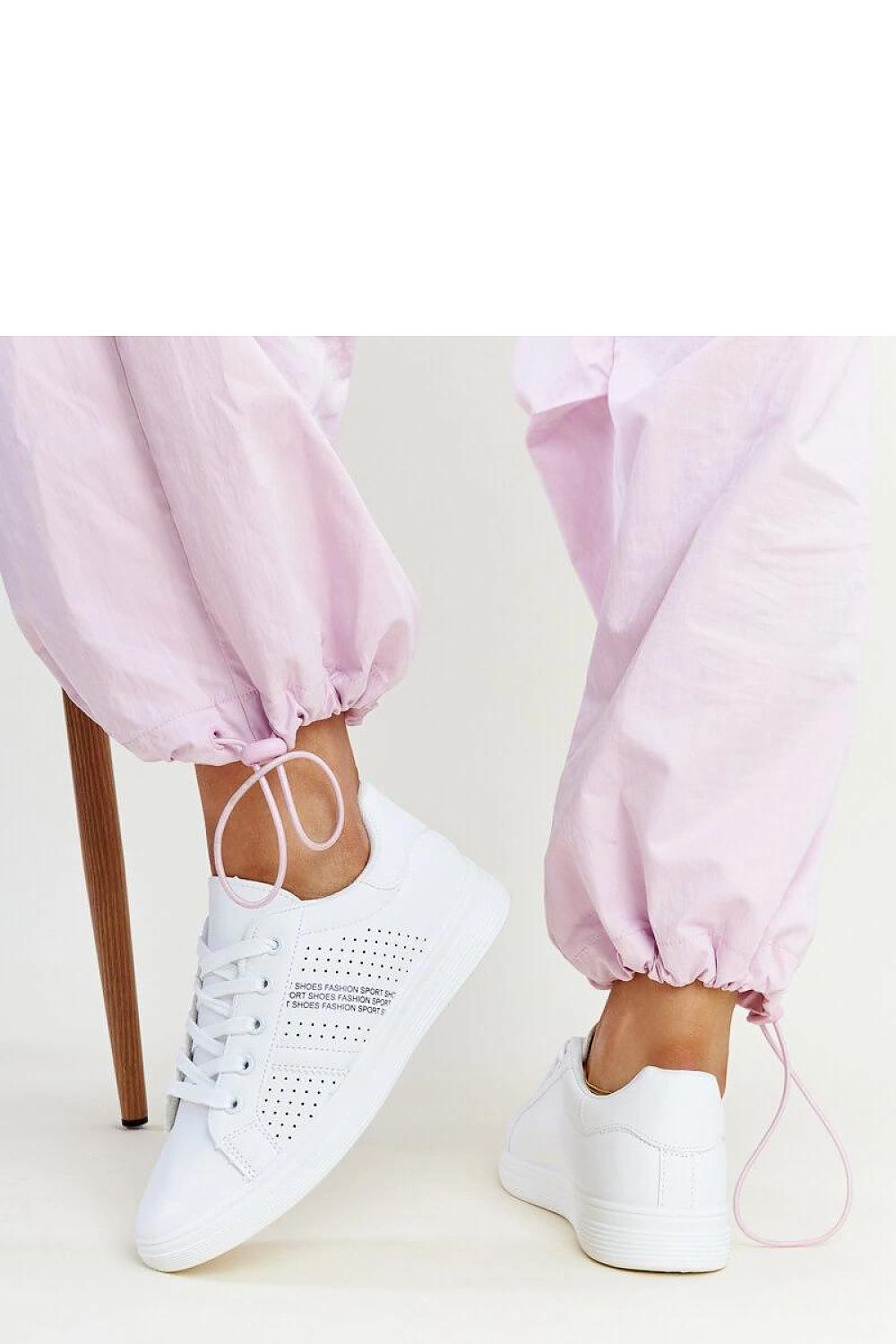 Elegant Solea Eco-Leather White Berdine Sneakers on a model, demonstrating their versatile style for both casual and chic occasions.