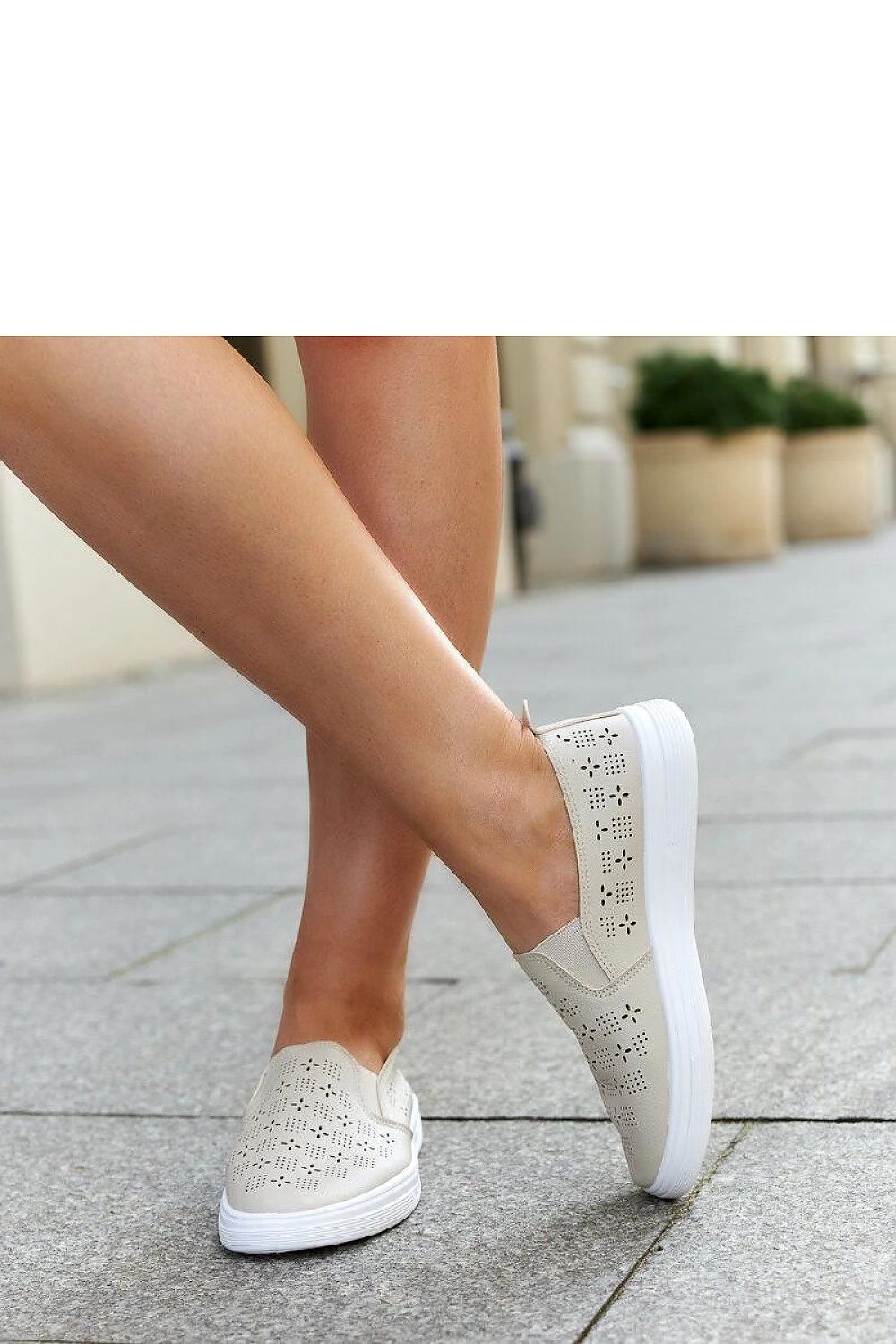 Close-up of Solea Beige Slip-On Sneakers, highlighting the decorative perforation and rounded toe, perfect for warm days.