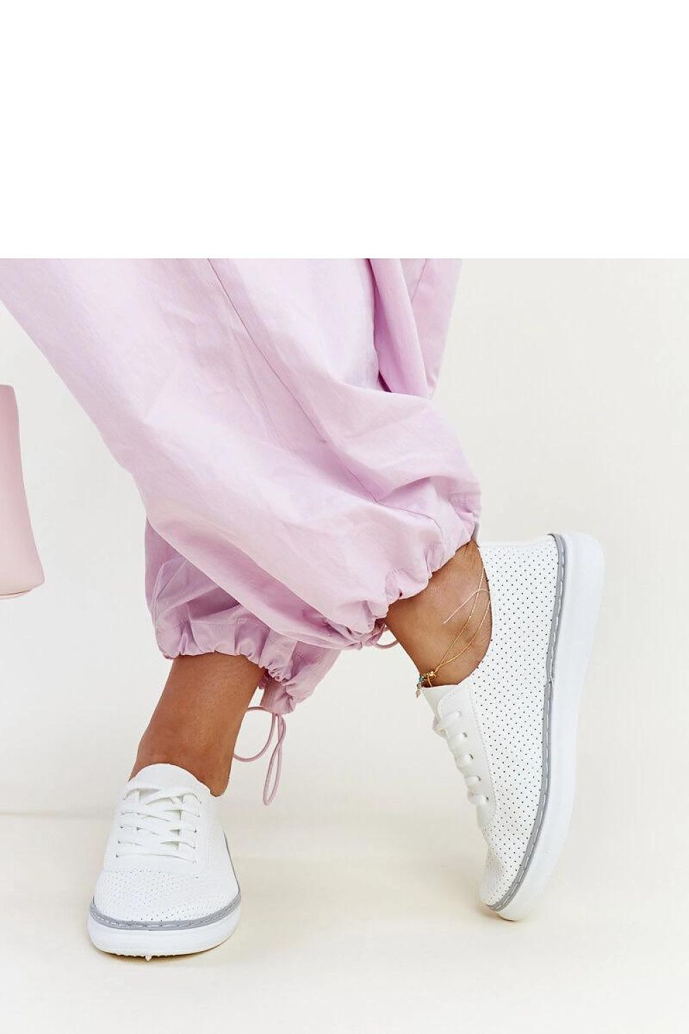 Solea Biserka White and Grey Sneakers showcased on a stylish backdrop, ideal for adding a touch of luxury to any active outfit.