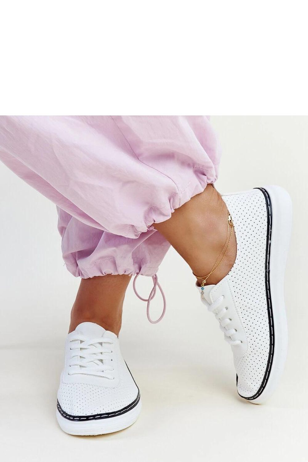 Side angle of Soloea Biserka white and grey sneakers, emphasizing the rubber sole and stylish lace-up closure for enhanced stability.