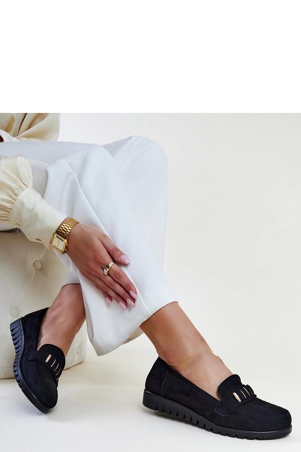 Sophisticated Solea black patent loafers with a decorative strap, showcasing a modern design perfect for stylish women.