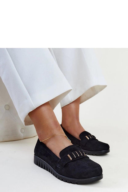 Elegant Solea black patent loafers featuring a unique decorative strap and almond-shaped toe, ideal for fashionable everyday wear.