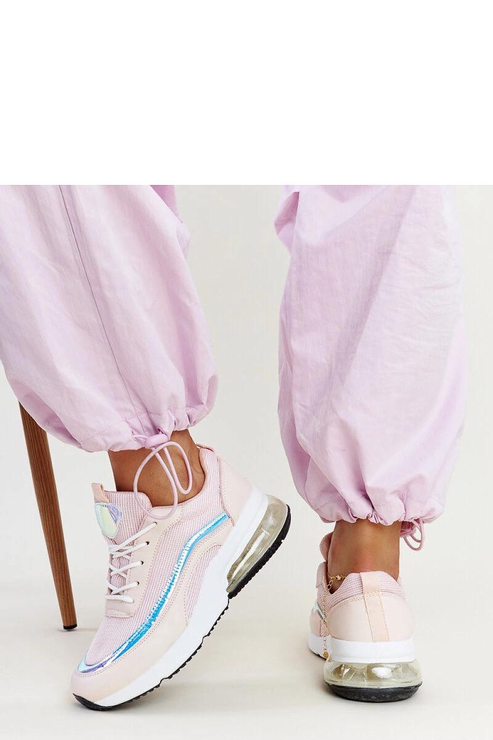 Side profile of Solea pink hologram Jelka sneakers featuring a medium heel and lace-up closure, ideal for trendsetters.