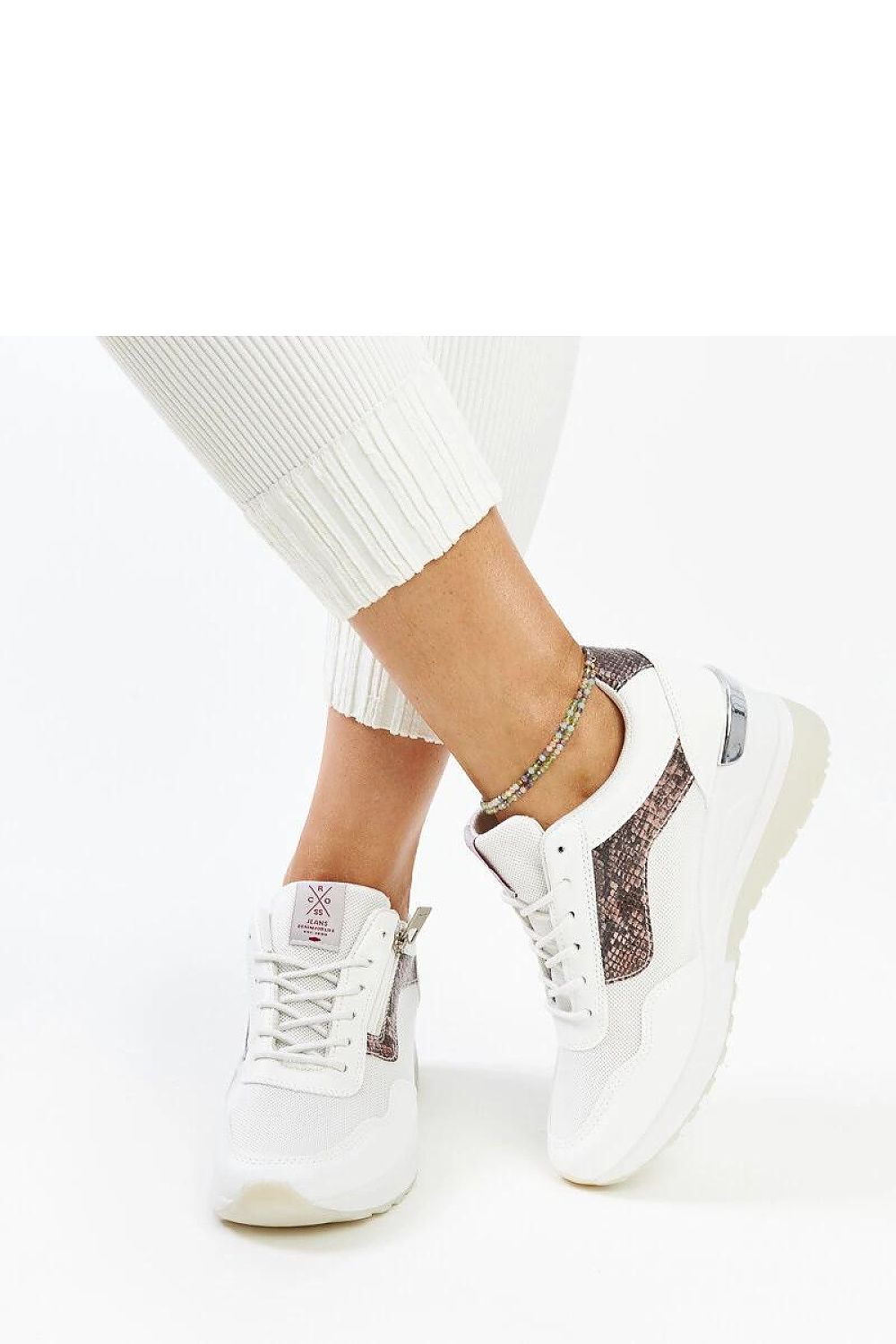 Close-up of Solea's white women's wedge sneakers, emphasizing the high-quality craftsmanship and stylish lacing for a chic look.