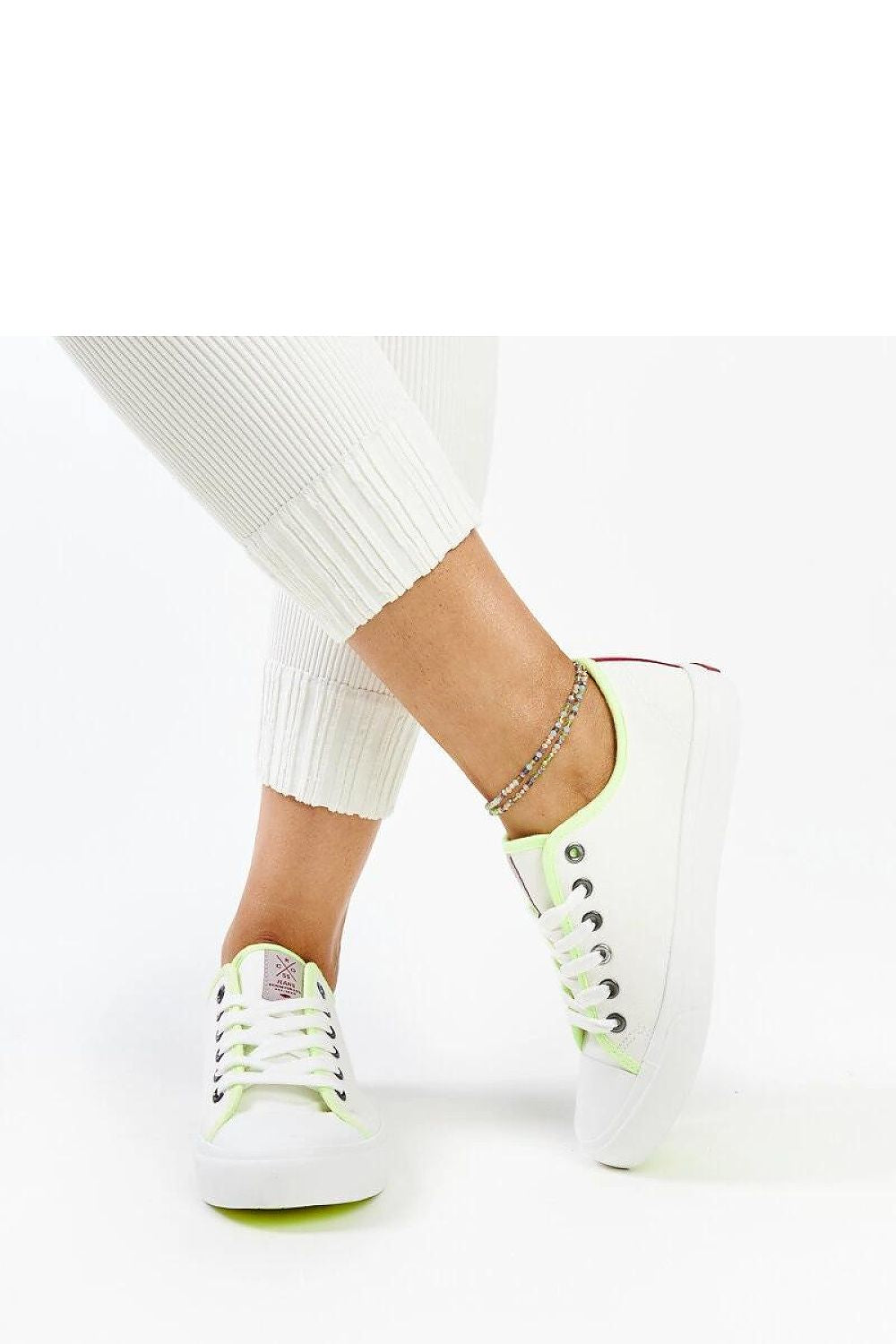 Close-up view of the luxurious white fabric and durable sole of Solea women's sneakers, highlighting the rounded toe and sophisticated urban fashion appeal.