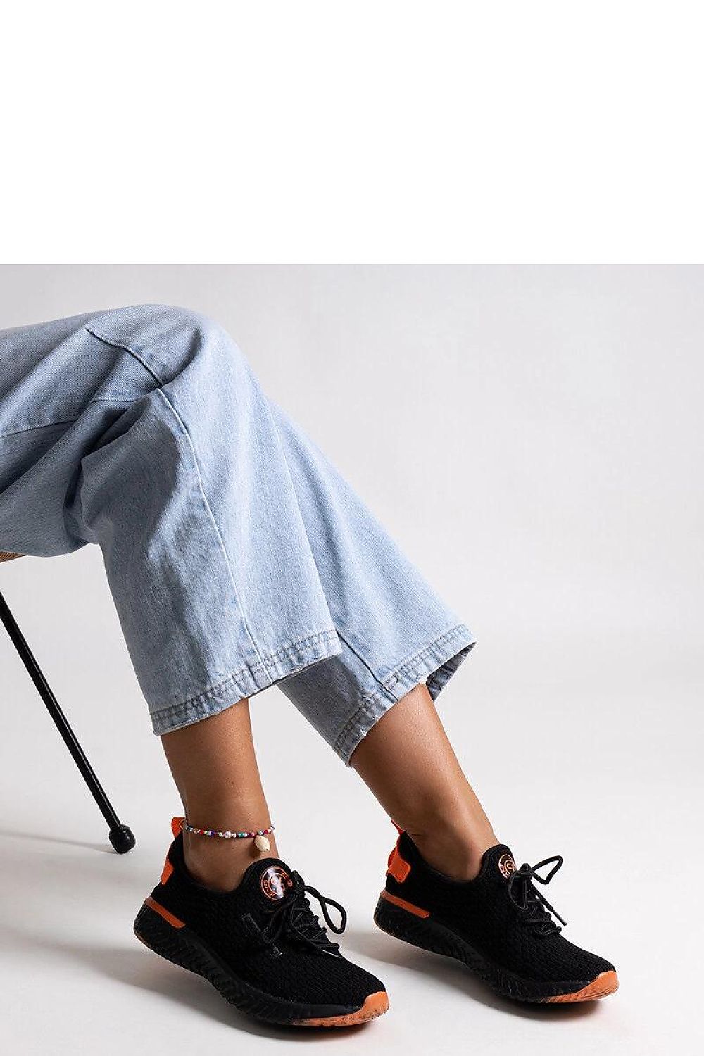 Elegant black women's sneaker by Solea, featuring a modern design, lace-up closure, and a comfortable rubber sole, perfect for stylish spring and summer outfits.