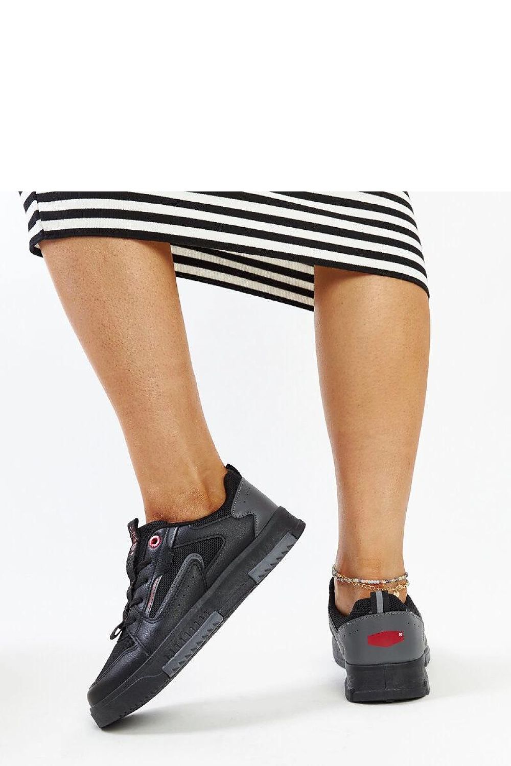 Close-up view of Solea Ladies' black and grey sneakers showcasing high-quality materials and comfortable rubber sole for luxury everyday wear.