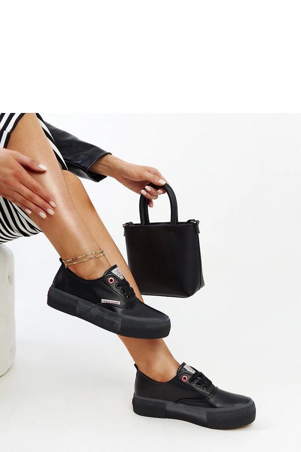 Solea women's black sneakers displayed with laced closure, blending comfort and sophistication for the discerning fashionista.