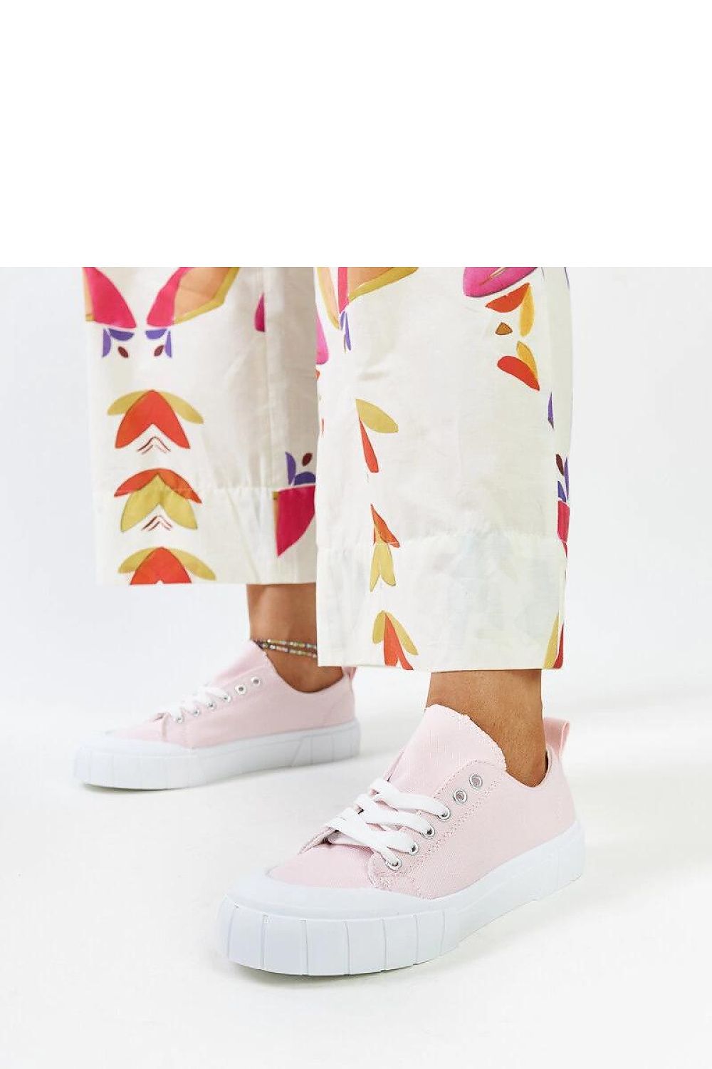 Solea women's light pink sneakers displayed outdoors, highlighting the fresh color and soft fabric, a perfect addition to any chic outfit.