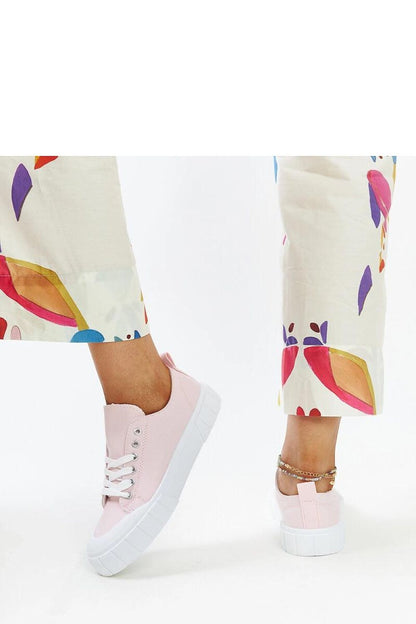 Solea elegant light pink fabric sneakers for women displayed in a stylish setting, showcasing their sleek design and comfortable rounded toe.