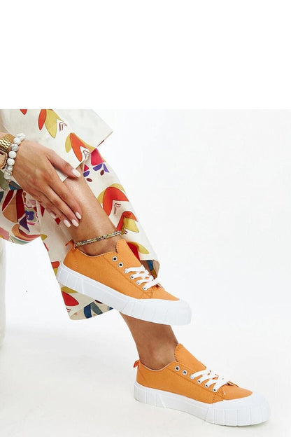 A pair of Solea fabric sneakers in light pink, artfully placed to emphasise their luxury fit and fashionable appeal for women.