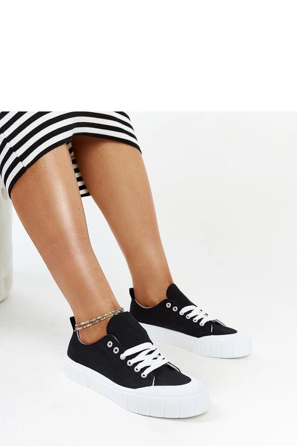 Solea light pink women's sneakers displayed with summer attire, showcasing their luxurious fabric and fashionable appeal for seasonal elegance.