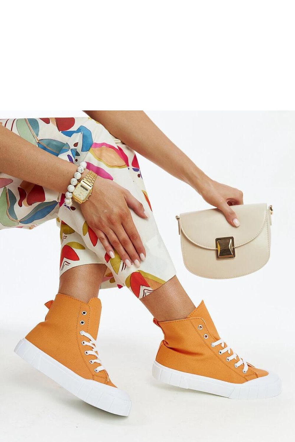 Solea pink high-top sneakers displayed on a pedestal, exuding modern charm and comfort for the fashion-forward woman.