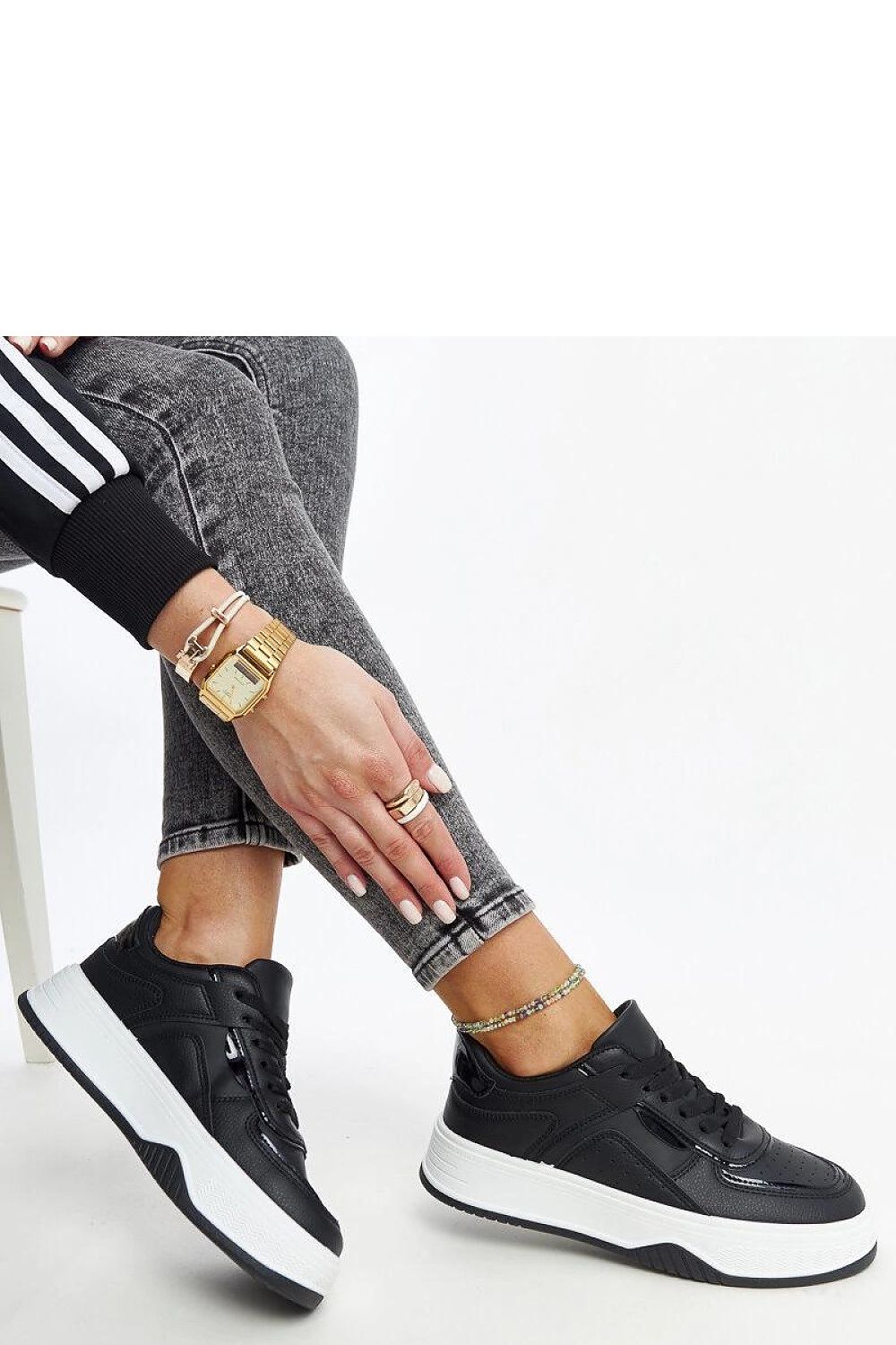 Elegant Solea black sneakers featuring a thick rubber sole, embodying stylish design and comfort, perfect for casual outfits.