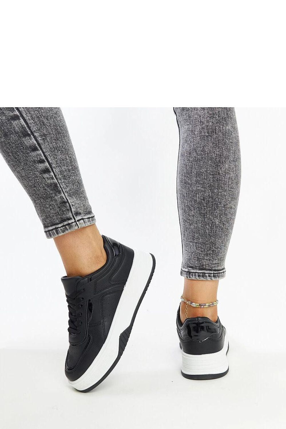 Chic Solea black lace-up sneakers with a trendy low profile and robust rubber sole, ideal for fashionable young adults.