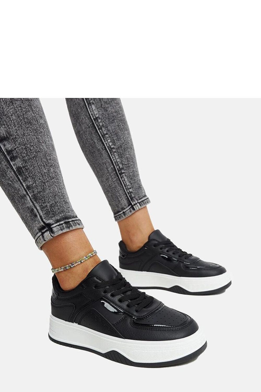 Contemporary Solea black sneakers showcasing a fashionable round toe and thick sole, designed for superior grip and comfort.