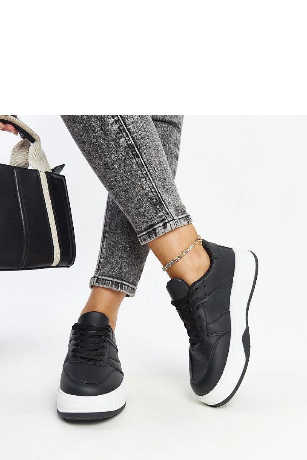 Close-up of Solea black sneakers highlighting the round toe and durable rubber sole, perfect for street fashion enthusiasts seeking comfort and elegance.