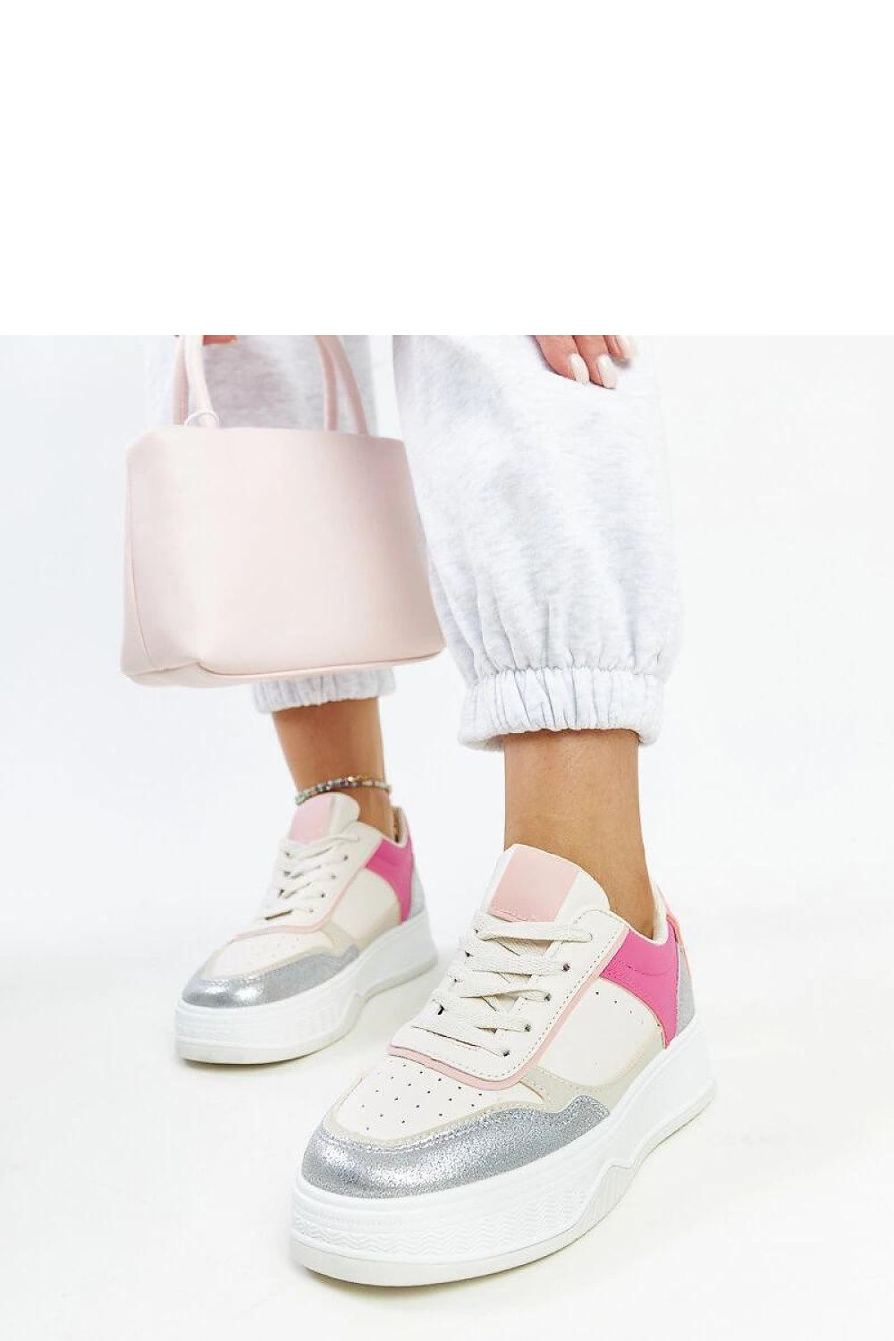 Elegant lace-up design of Solea's chunky soled white and pink sneakers, perfect for enhancing streetwear aesthetics this spring/summer.