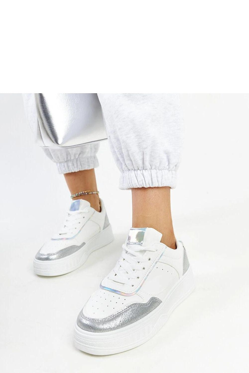 Solea White & Silver Sneakers featuring a stylish thicker sole and lace-up design, perfect for luxurious spring and summer outings.