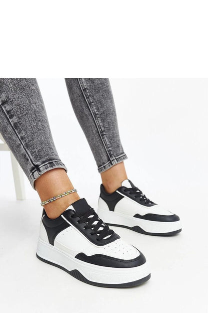 Luxury black and white sneakers by Solea featuring a thick sole and stylish design, perfect for a modern look.