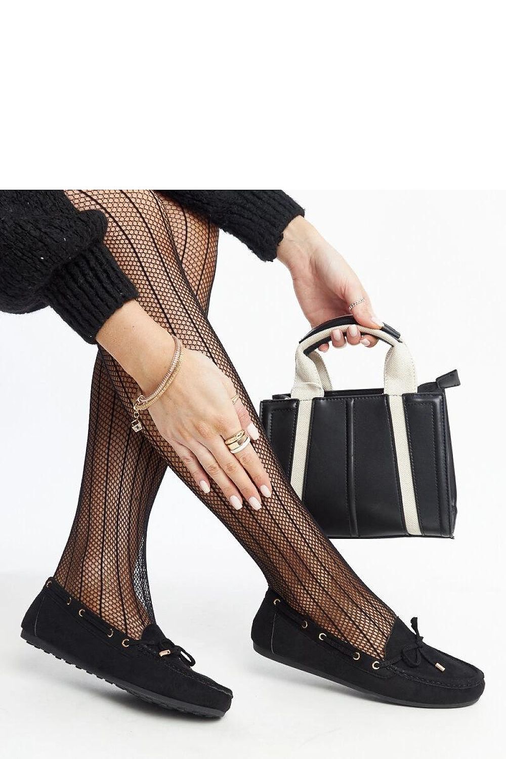 Solea's chic navy blue moccasins displayed on a flat surface, highlighting their rubber sole and fashionable almond-shaped toe.