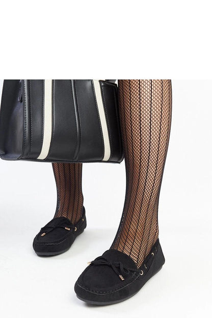 Elegant presentation of Solea's luxurious navy blue moccasins, perfect for spring and summer, embodying a blend of comfort and style.