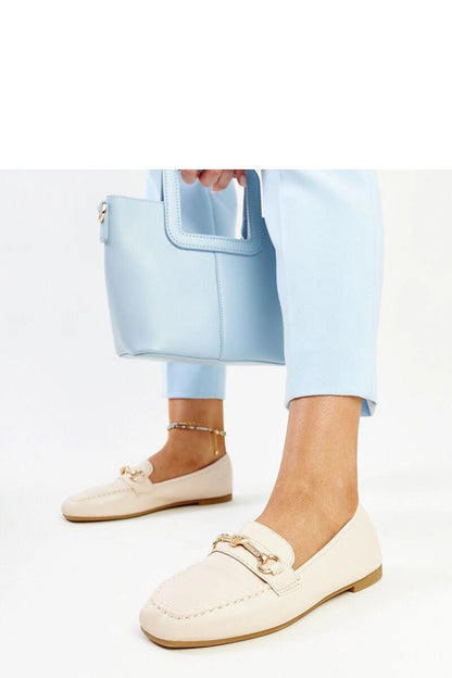 Lifestyle image of Solea light beige moccasins styled with summer attire, exemplifying comfort and luxury for warm days.