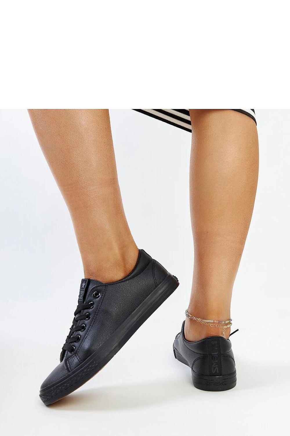 Chic black eco-leather sneakers designed by Solea, showcasing modern elegance with a round toe and cushioned rubber sole for women.