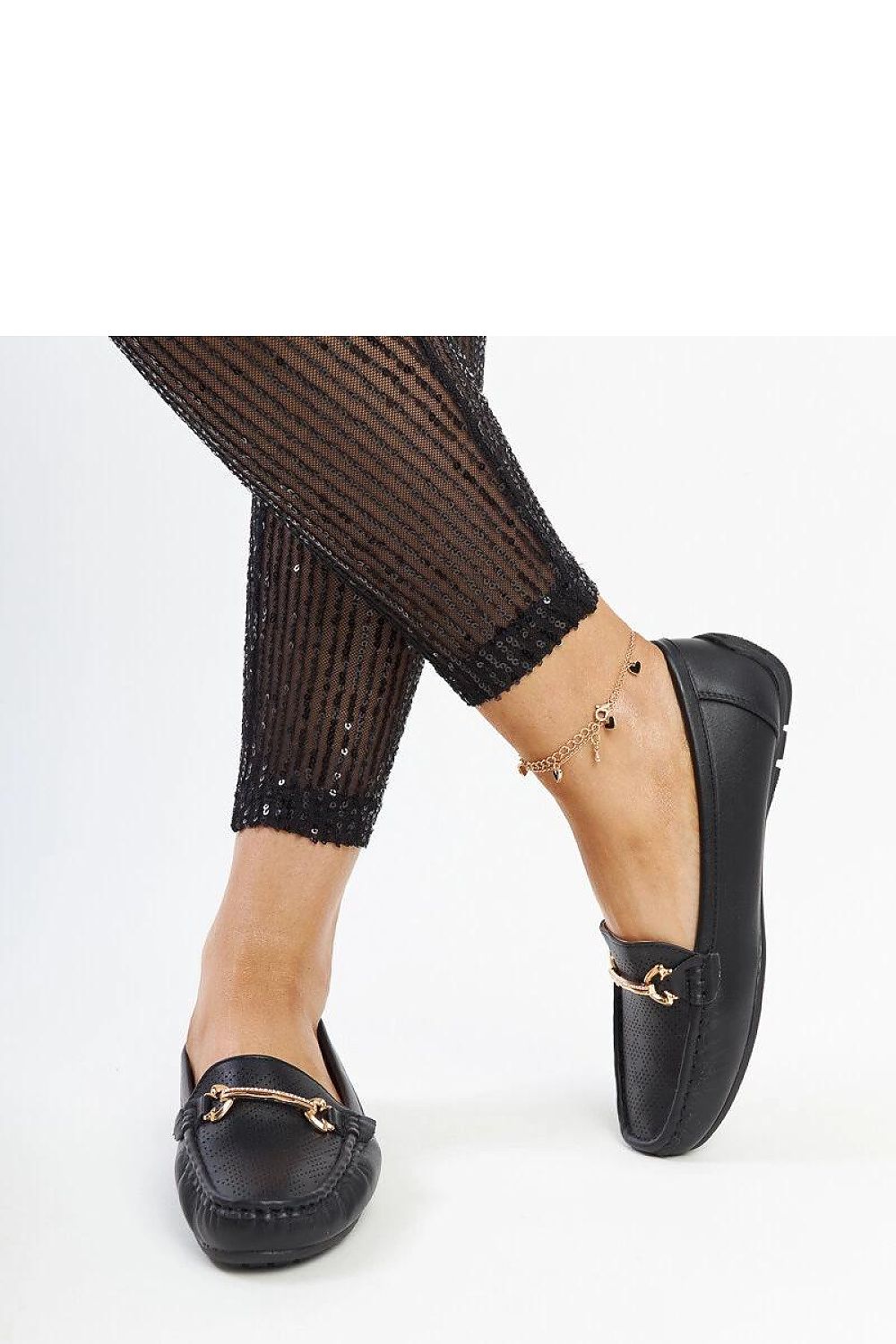 Elegant black slip-on loafers by Solea featuring a decorative rhinestone buckle, designed for comfort and style in EU sizes 36-41.