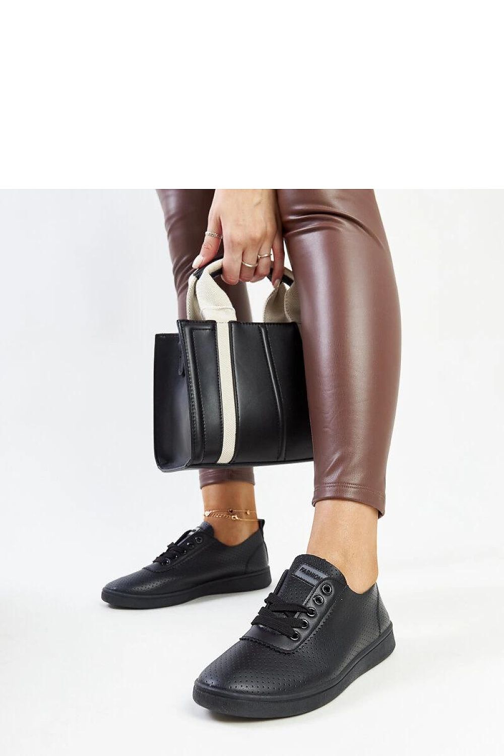 Elegant black eco-leather sneakers for women from Solea, the Yusra style combines comfort with sophistication for all-day wear.