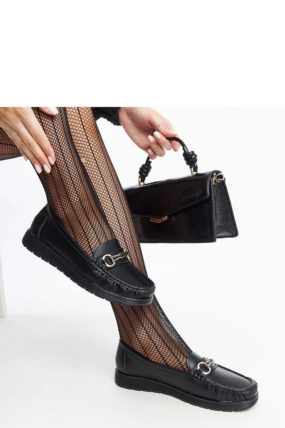 Close-up of Solea black Anisah loafers highlighting the refined buckle detail and sustainable eco-friendly leather craftsmanship.