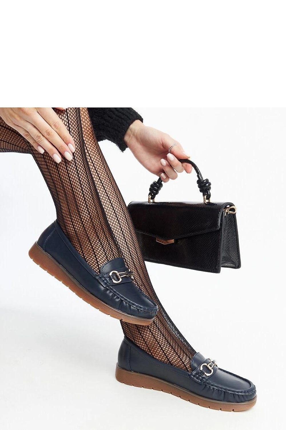 Styled shot of Solea black Anisah loafers, blending elegance and comfort, demonstrating the perfect choice for spring and summer outings.