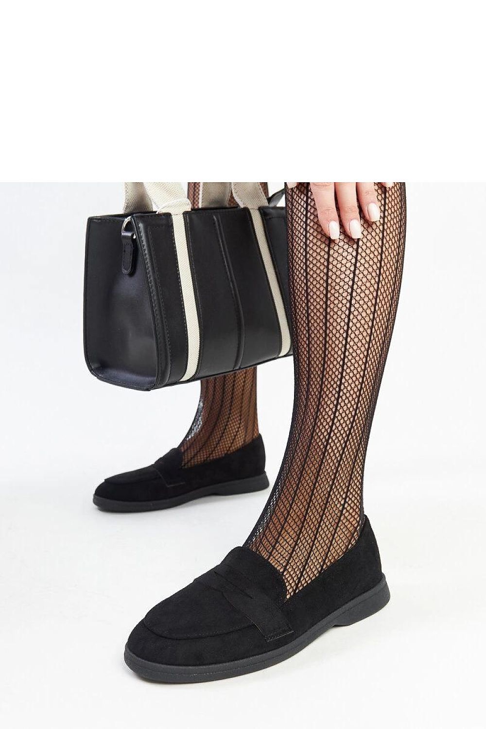 Versatile black suede loafers by Solea paired with summer attire, illustrating their ease and sophistication as slip-on shoes.