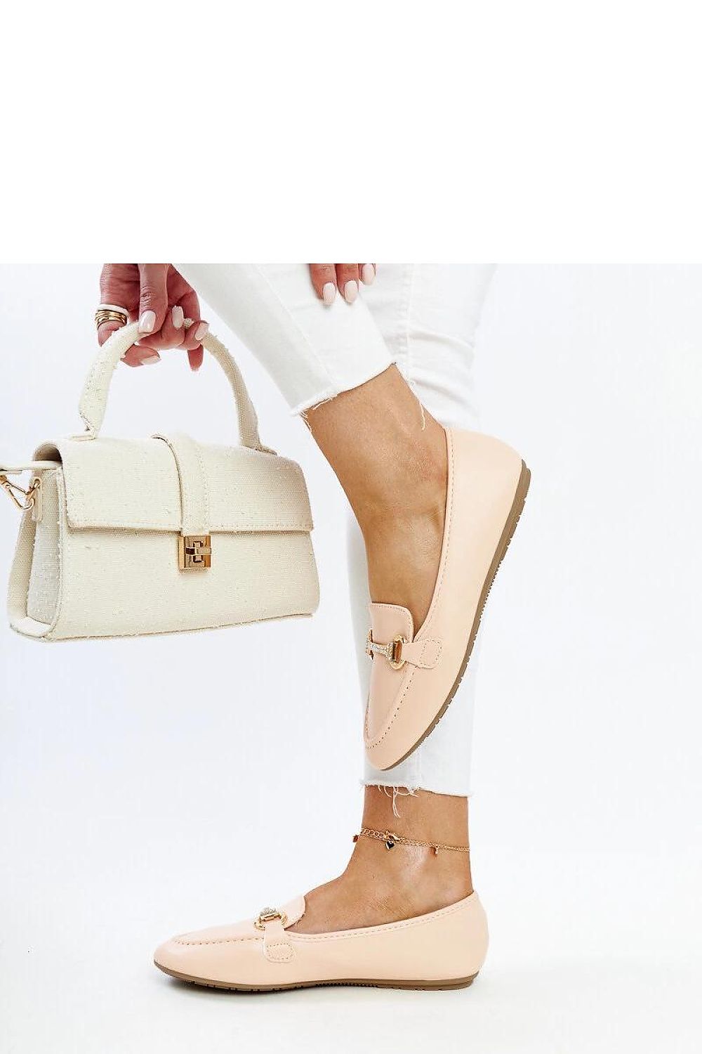 Close-up of Solea's luxury beige loafers, highlighting the rhinestone detailing and eco-conscious leather craftsmanship.