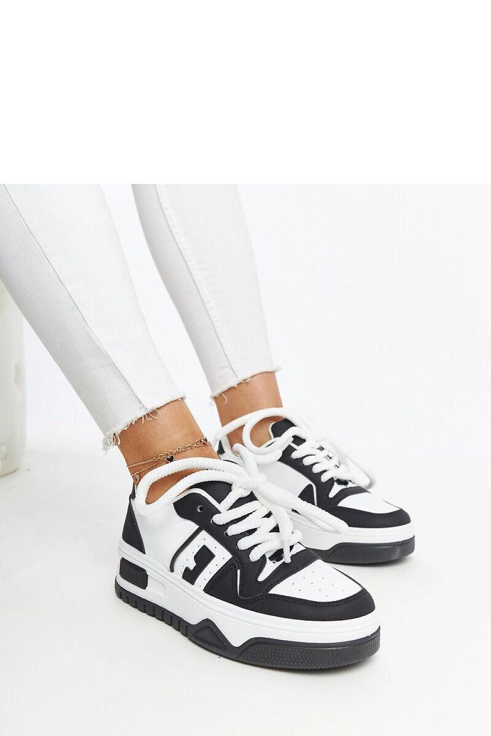 Close-up of Solea eco-leather sneakers in black and white, highlighting the lace-up closure and chic design suited for every outfit.