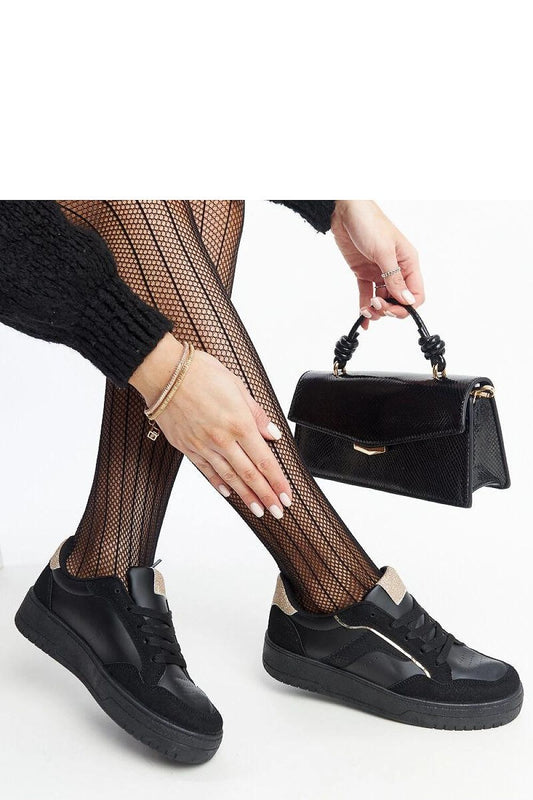 Close-up view of Solea luxury black platform sneakers showcasing the quality of the lace-up design and comfortable rubber sole for effortless style.