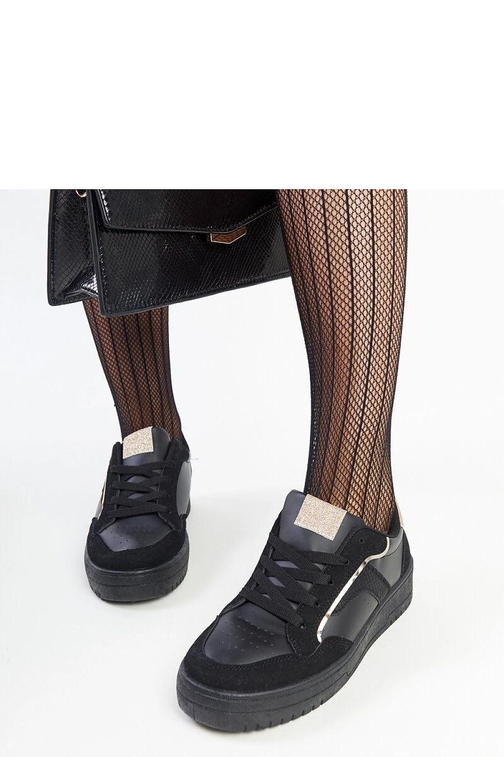 Solea's black platform sneakers displayed against a minimalist background, exemplifying luxury and versatility for any outfit, with a 4 cm heel height.