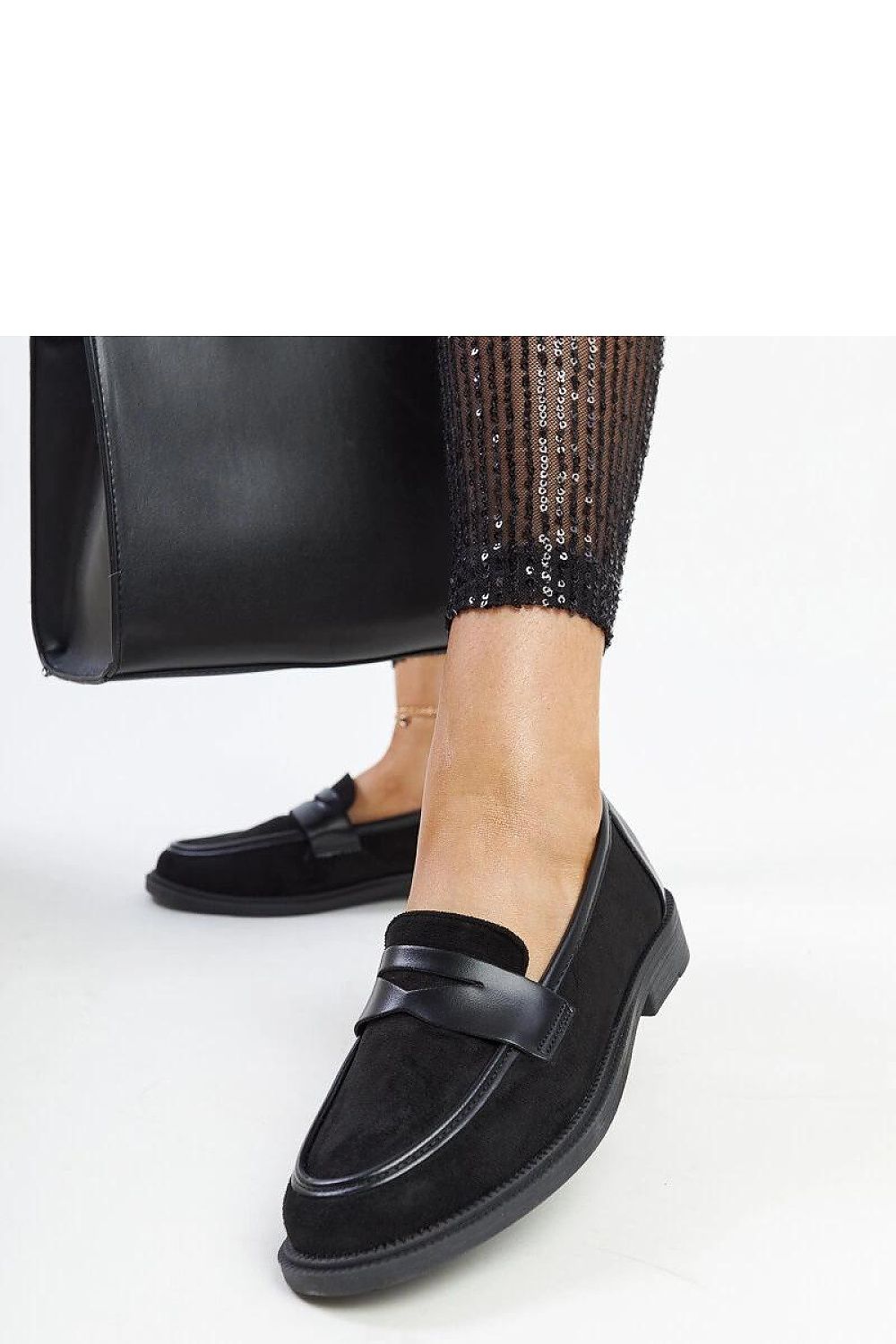 Solea chic black suede moccasins displayed elegantly, demonstrating their timeless design and comfort for every woman’s wardrobe.